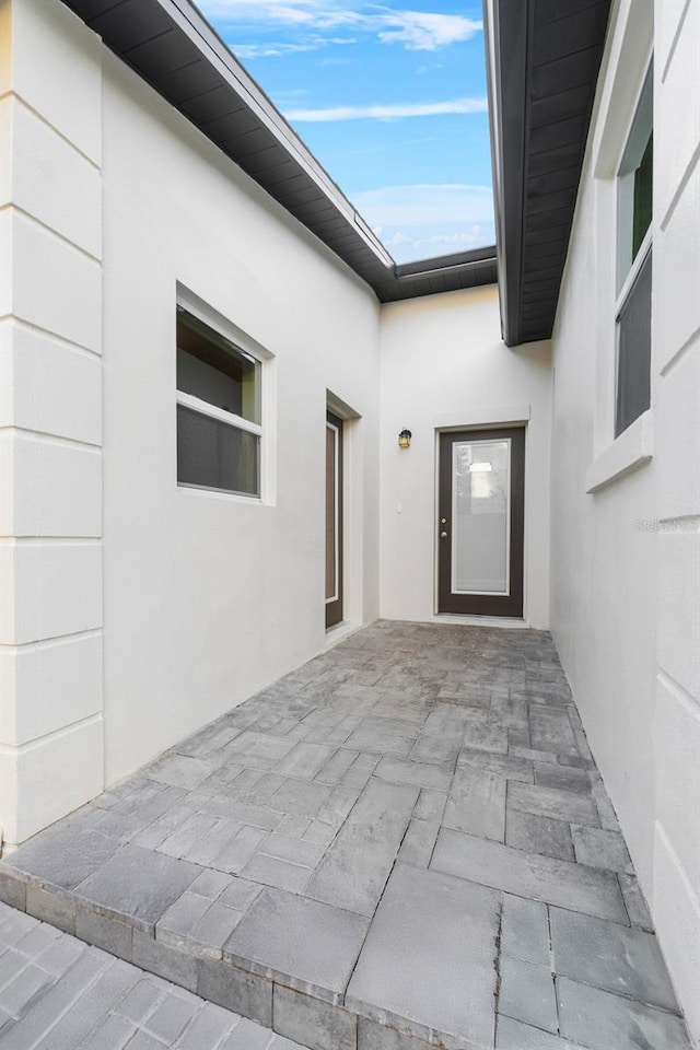 entrance to property featuring a patio