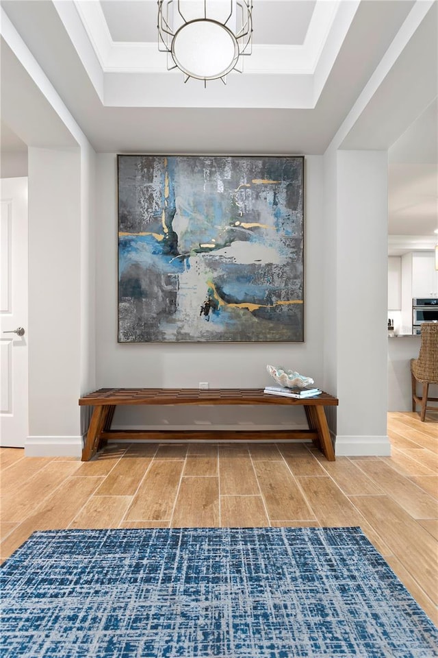 interior details with hardwood / wood-style flooring, stainless steel oven, and a raised ceiling