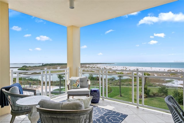 balcony featuring a water view and a view of the beach