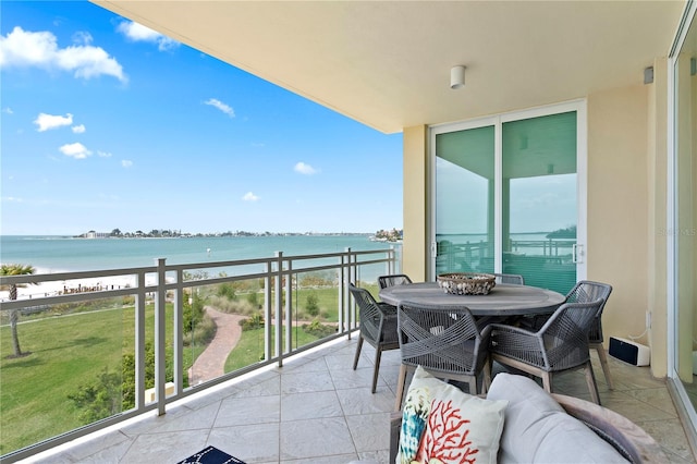 balcony with a water view and a beach view