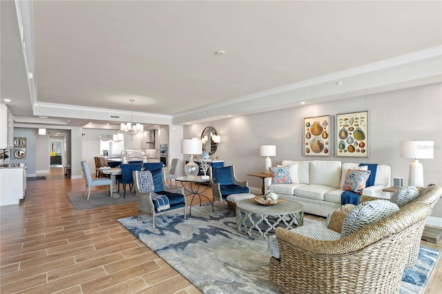 living room featuring a notable chandelier and light hardwood / wood-style floors