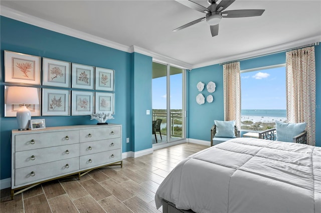 bedroom with light hardwood / wood-style floors, access to outside, a water view, and ceiling fan