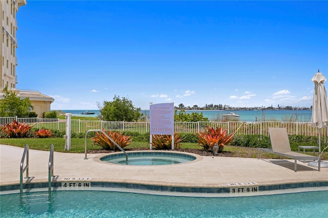 view of pool featuring a community hot tub and a water view