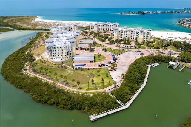 drone / aerial view featuring a water view and a view of the beach