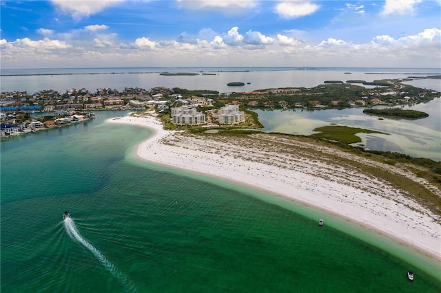 birds eye view of property with a water view and a view of the beach