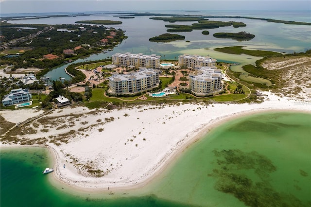 drone / aerial view featuring a water view and a view of the beach