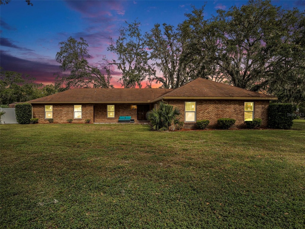 ranch-style house featuring a lawn