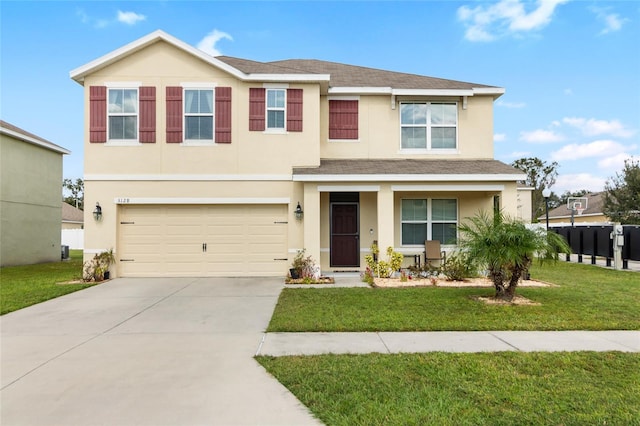 view of front of property featuring a front yard and a garage