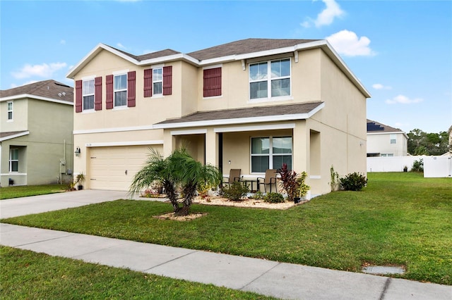 view of front of property with a front yard and a garage