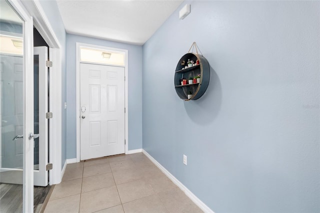 foyer entrance with light tile patterned floors