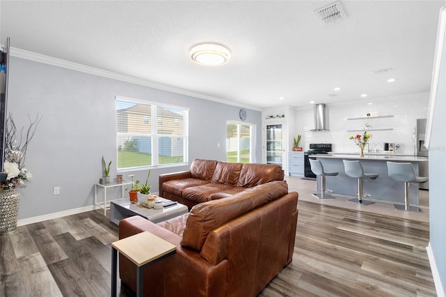 living room with crown molding and light hardwood / wood-style flooring