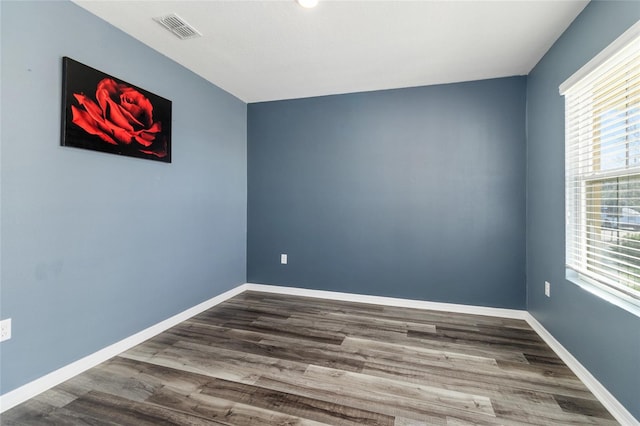 spare room featuring wood-type flooring