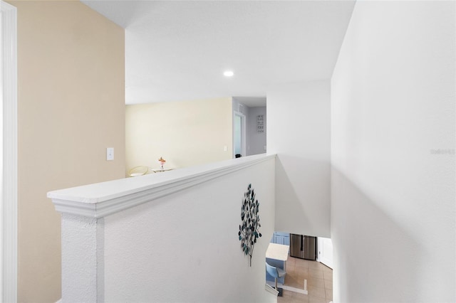 corridor with light tile patterned floors