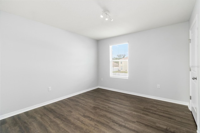 spare room with dark hardwood / wood-style flooring