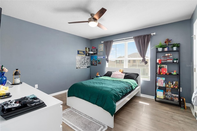 bedroom featuring hardwood / wood-style floors and ceiling fan