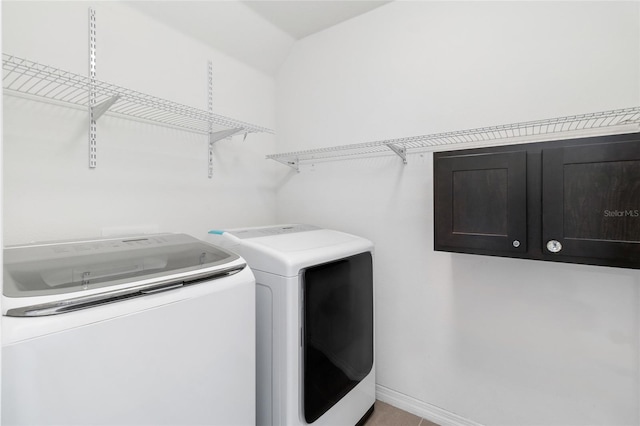 laundry room with cabinets and separate washer and dryer