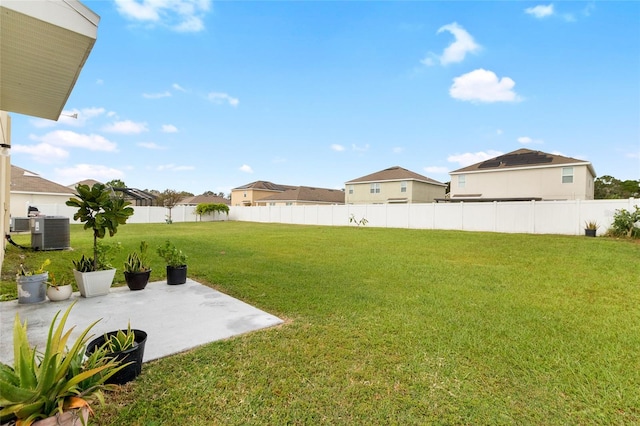 view of yard with central AC and a patio area