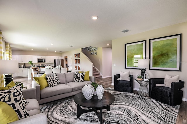 living room with hardwood / wood-style flooring and a textured ceiling