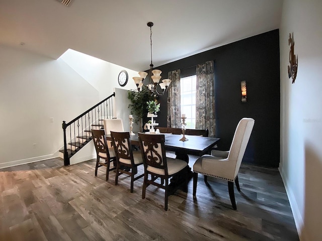 dining room featuring wood-type flooring and a notable chandelier