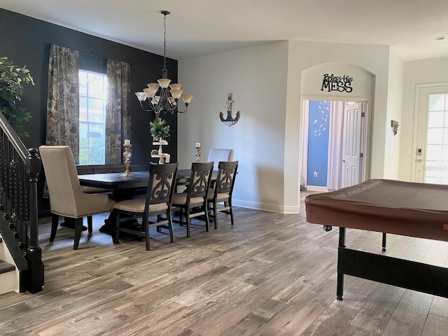 dining area with pool table, wood-type flooring, and an inviting chandelier