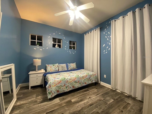 bedroom with ceiling fan and dark wood-type flooring