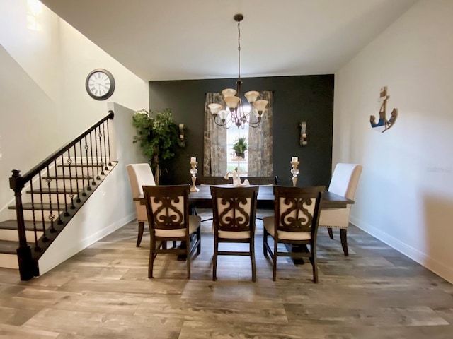 dining room featuring wood-type flooring and a notable chandelier