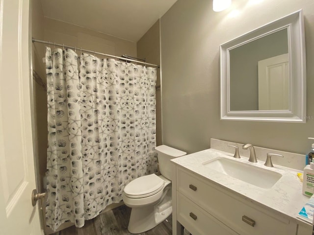 bathroom featuring hardwood / wood-style flooring, vanity, toilet, and a shower with curtain