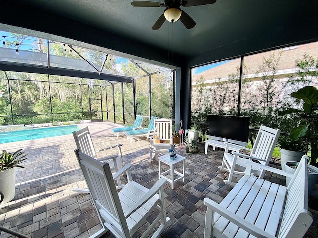 view of patio / terrace with ceiling fan and a lanai