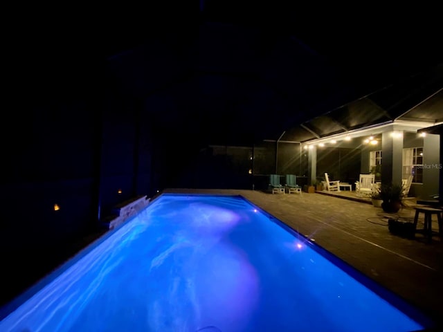 pool at night with a patio