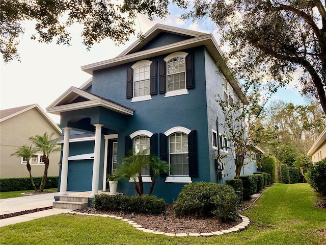 view of front facade with a garage and a front lawn