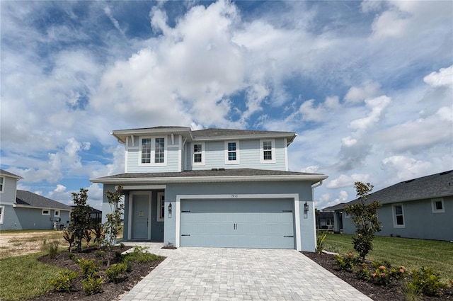 front facade with a front yard and a garage