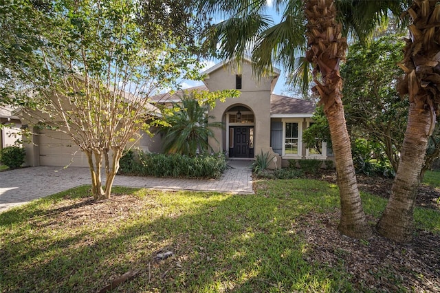 view of front of home with a front lawn and a garage