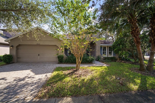 view of front of home with a garage and a front yard