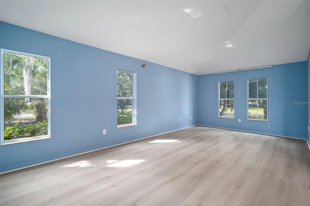 unfurnished room with light wood-type flooring