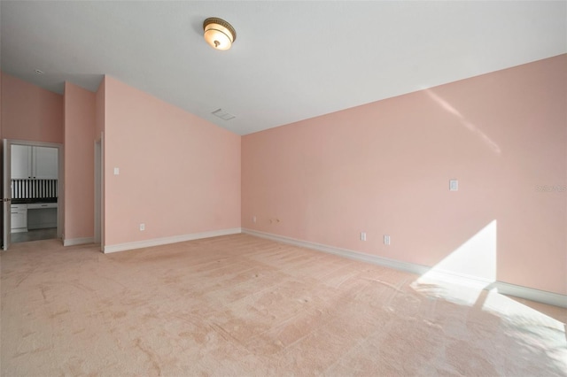 unfurnished living room featuring light colored carpet