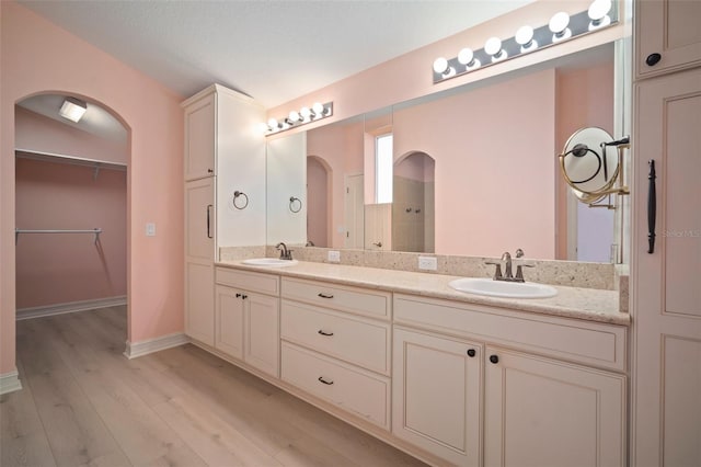 bathroom with vanity, wood-type flooring, and a textured ceiling