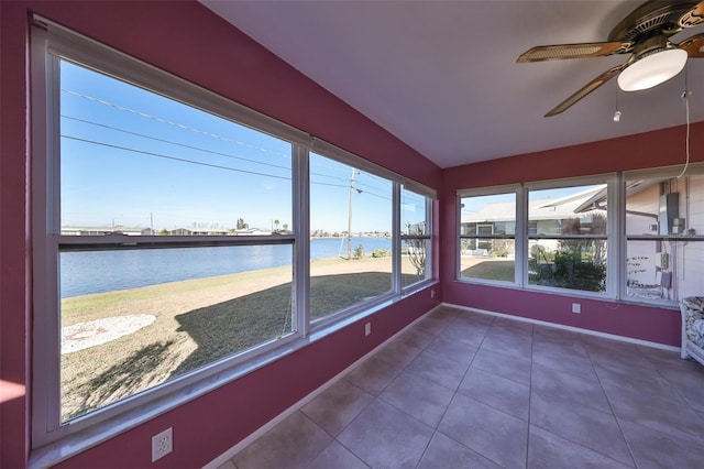 unfurnished sunroom with ceiling fan and a water view