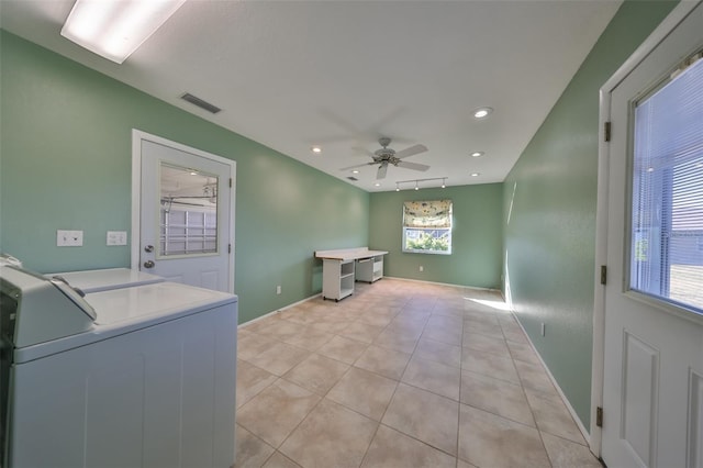 clothes washing area featuring separate washer and dryer, ceiling fan, and light tile patterned floors