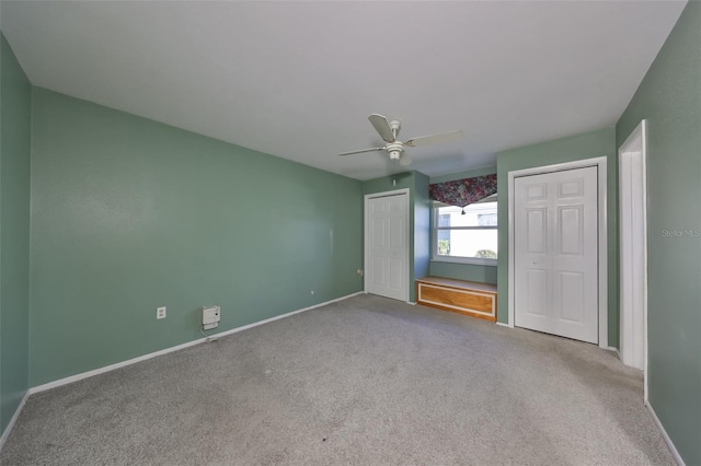 unfurnished bedroom featuring ceiling fan and light colored carpet