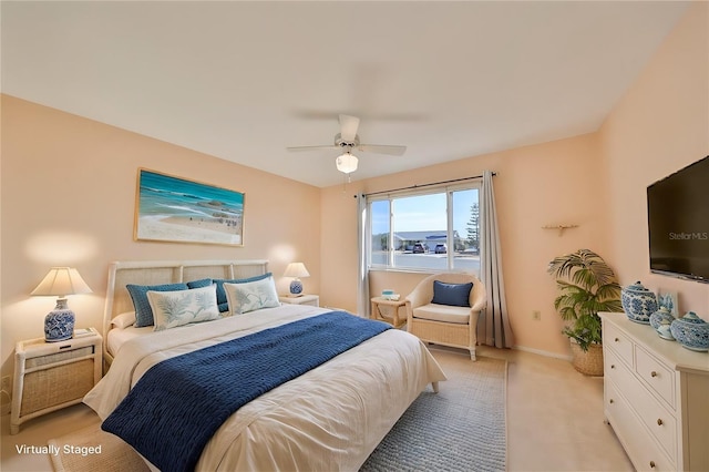 bedroom with ceiling fan and light colored carpet