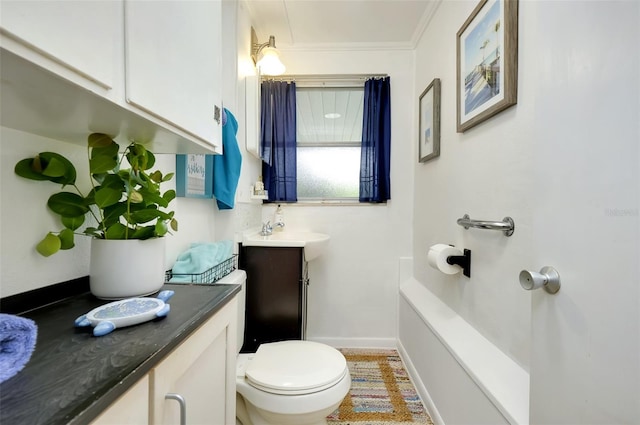 bathroom with vanity, crown molding, and toilet