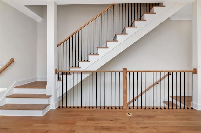 stairway featuring baseboards and wood finished floors