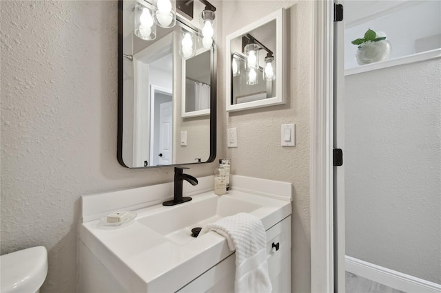 bathroom featuring vanity and toilet