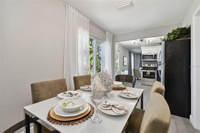 dining room with light hardwood / wood-style flooring