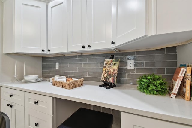 interior space featuring white cabinetry and tasteful backsplash