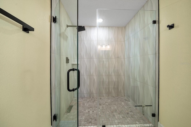 bathroom with a shower with door