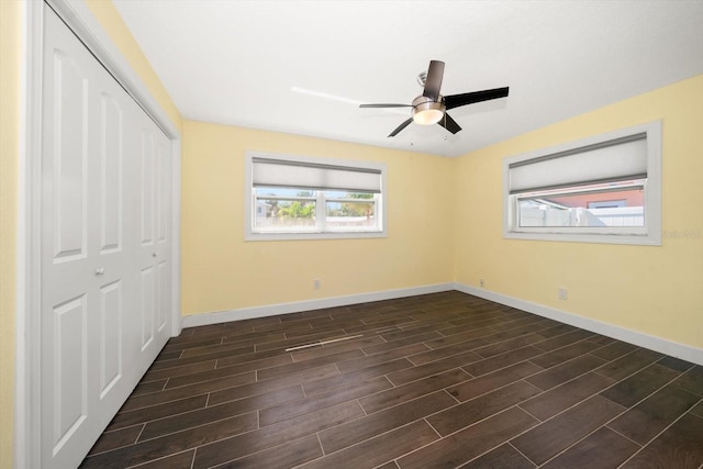 unfurnished bedroom with a closet, ceiling fan, and dark hardwood / wood-style floors