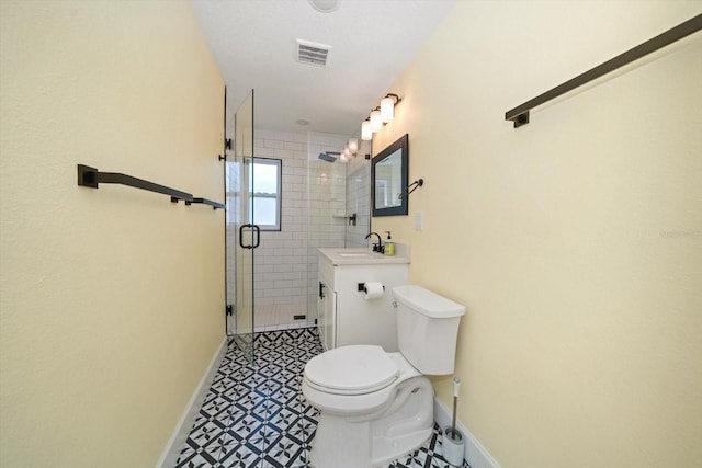 bathroom with vanity, a shower with shower door, and toilet