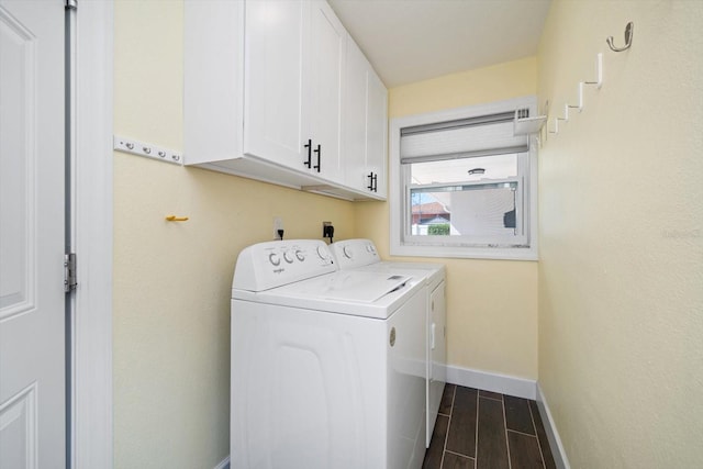 washroom with independent washer and dryer, cabinets, and dark hardwood / wood-style floors