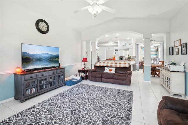 living room with ceiling fan, light tile patterned flooring, and vaulted ceiling